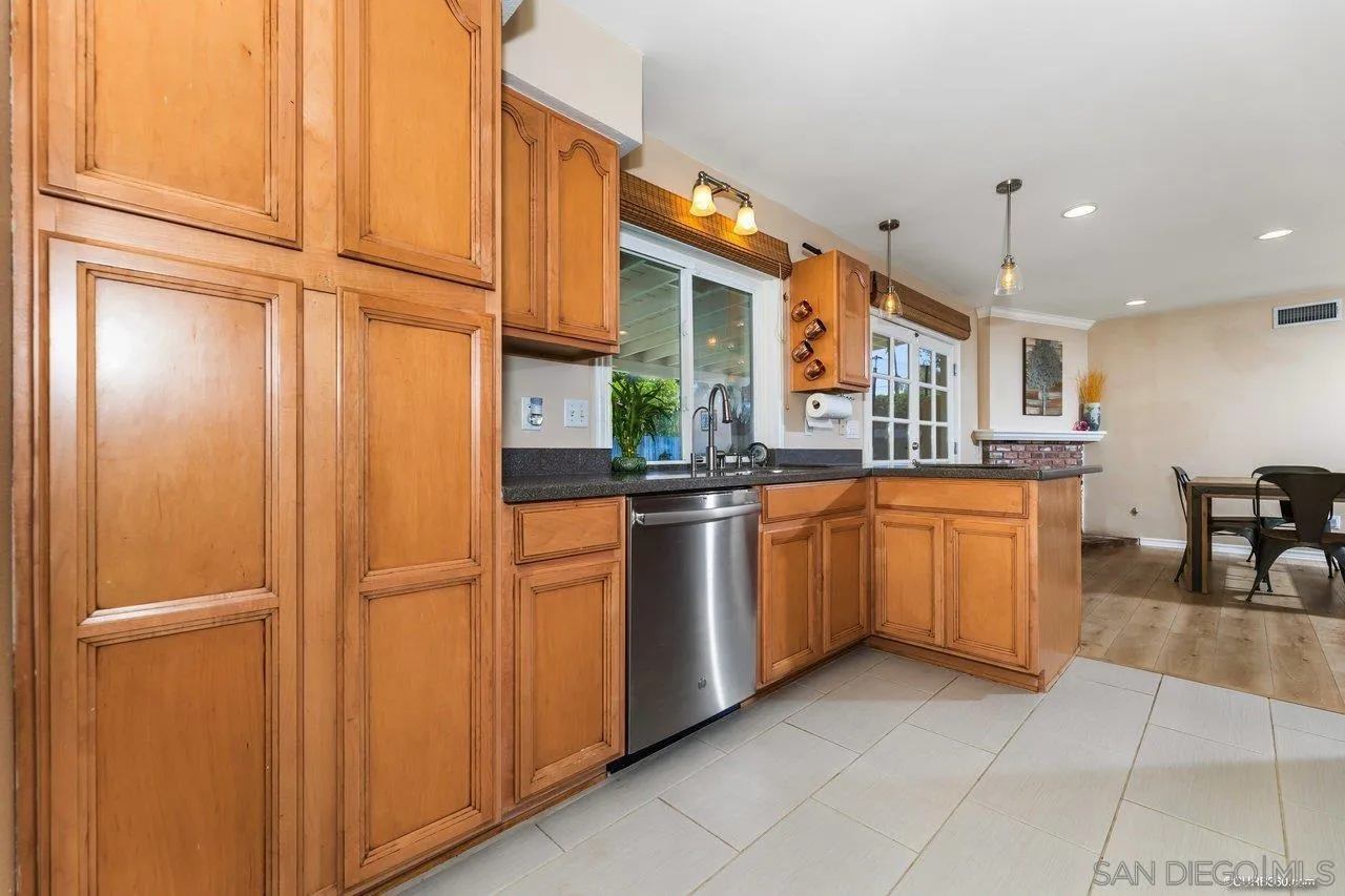 13317 Arikara Drive Poway, CA 92064 - Photo 15 of 52 a kitchen with a refrigerator and table