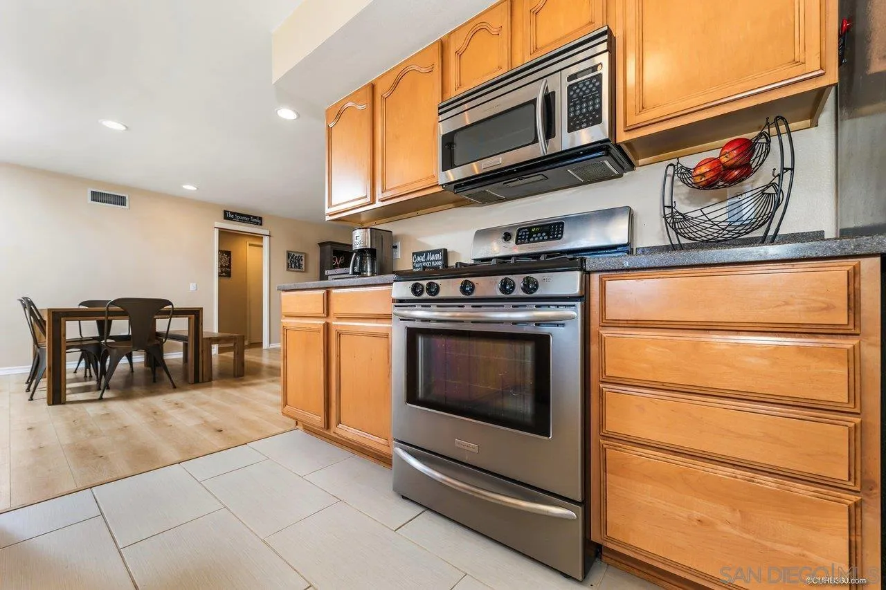 13317 Arikara Drive Poway, CA 92064 - Photo 16 of 52 a kitchen with stainless steel appliances granite countertop a stove and a refrigerator