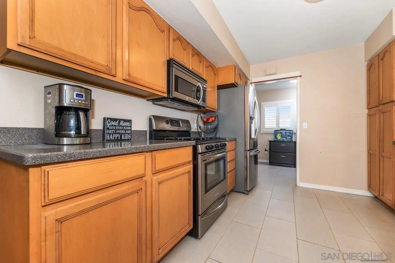13317 Arikara Drive Poway, CA 92064 - Photo 17 of 52 a kitchen with stainless steel appliances granite countertop a sink and cabinets
