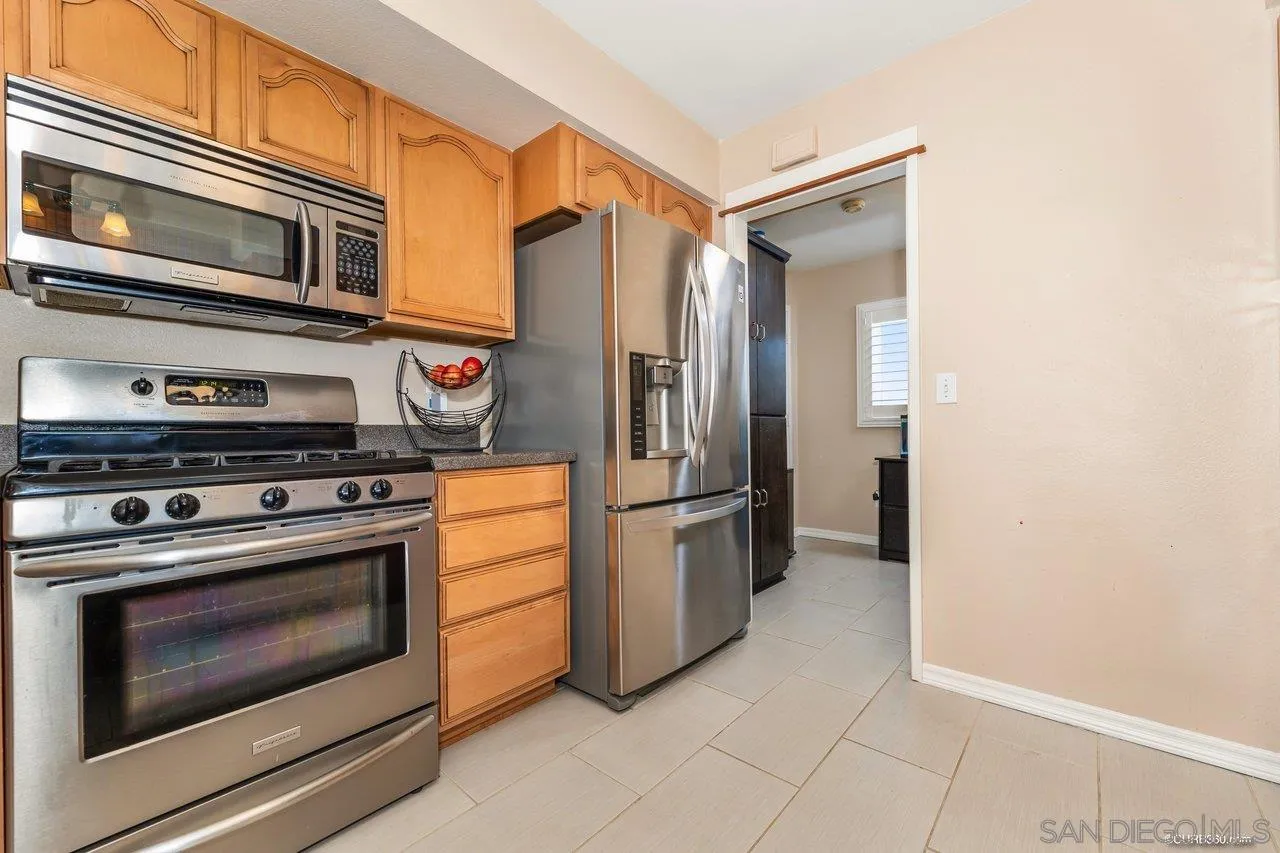 13317 Arikara Drive Poway, CA 92064 - Photo 19 of 52 a kitchen with a stove top oven and refrigerator