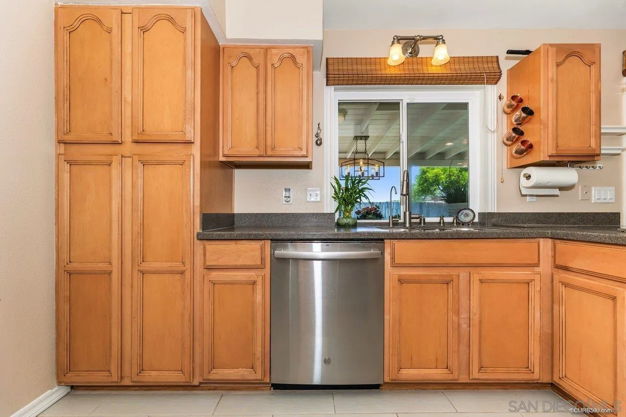 13317 Arikara Drive Poway, CA 92064 - Photo 21 of 52 a kitchen with stainless steel appliances granite countertop a refrigerator and a sink