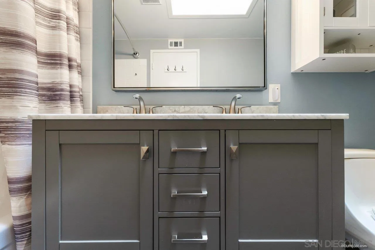 13317 Arikara Drive Poway, CA 92064 - Photo 35 of 52 a bathroom with a granite countertop sink and a toilet