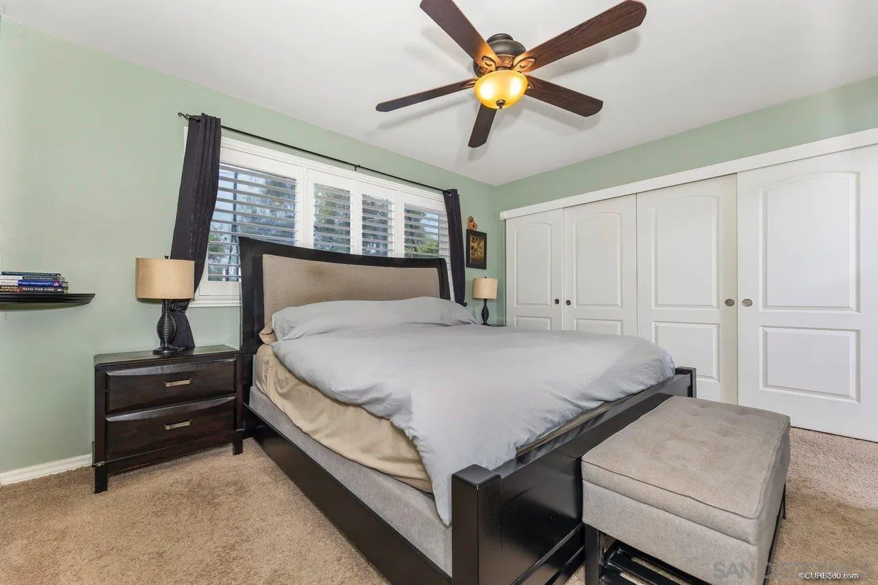 13317 Arikara Drive Poway, CA 92064 - Photo 36 of 52 a bedroom with a bed and a chandelier