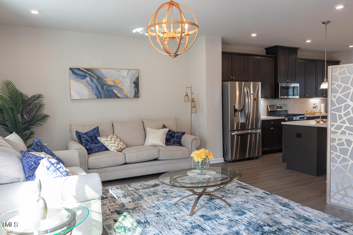 1505 Newpoint Drive Durham, NC 27713 - Photo 11 of 48 a living room with furniture and a kitchen view