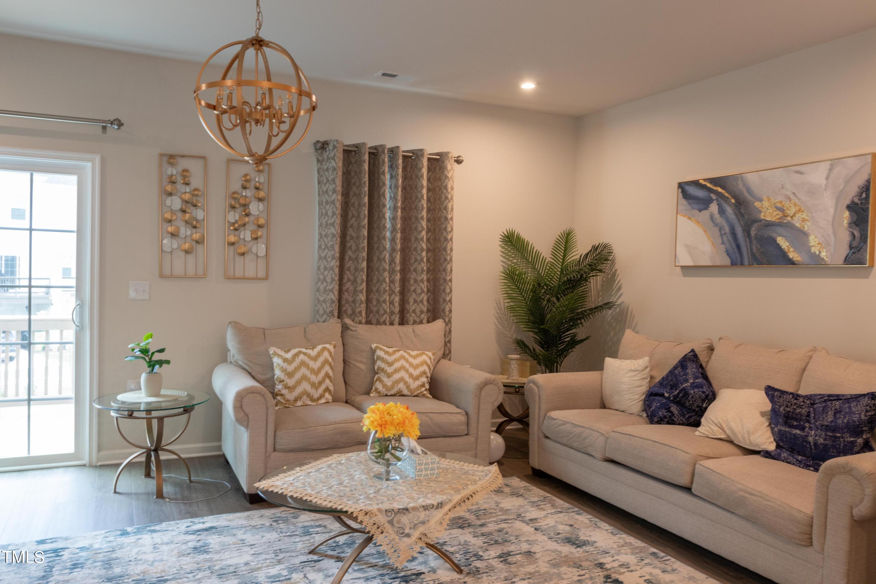 1505 Newpoint Drive Durham, NC 27713 - Photo 12 of 48 a living room with furniture and a chandelier