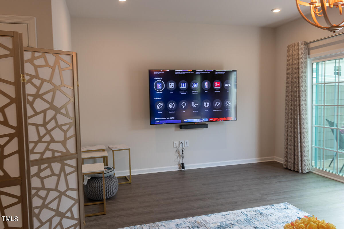 1505 Newpoint Drive Durham, NC 27713 - Photo 13 of 48 an empty room with wooden floor and cabinet