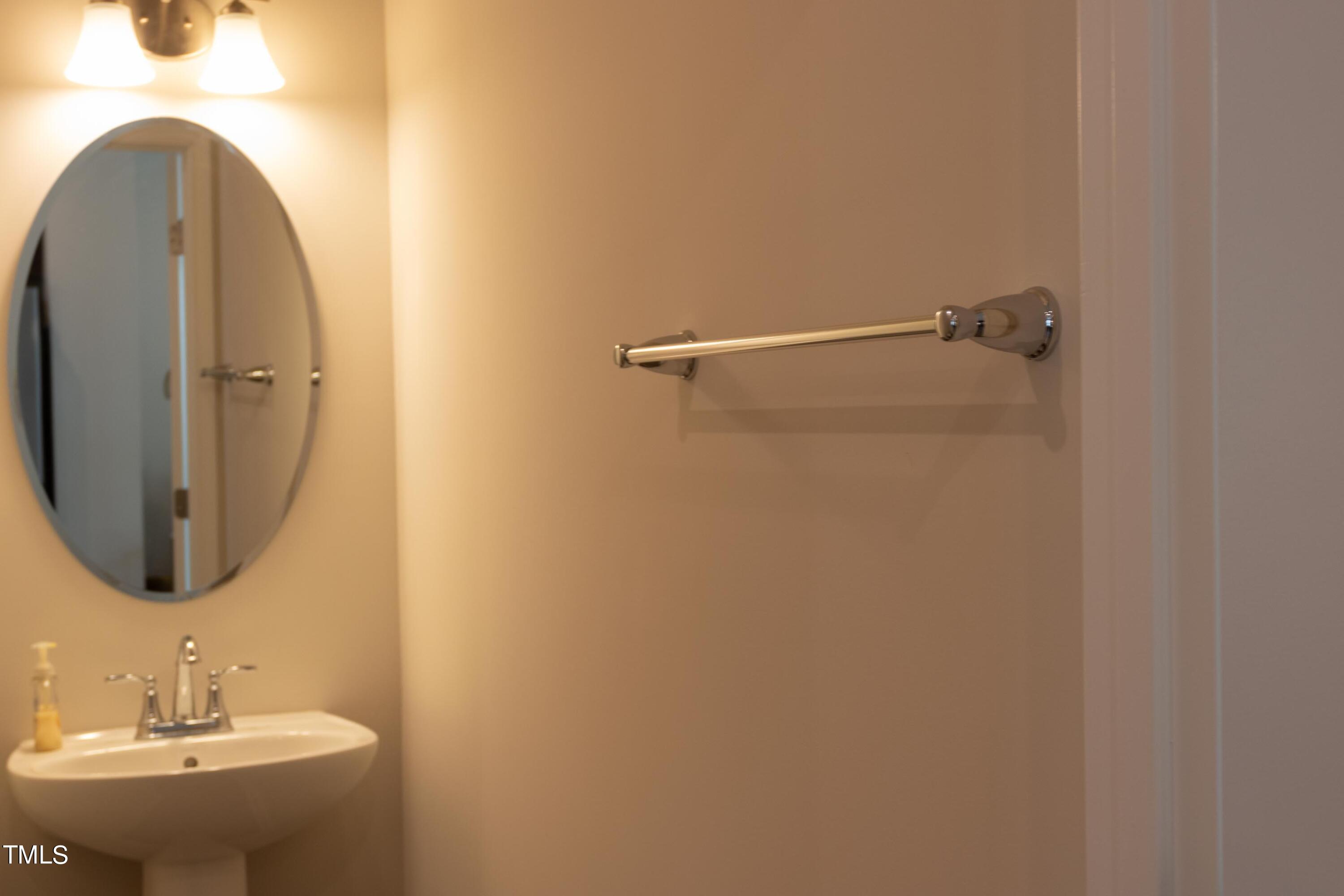 1505 Newpoint Drive Durham, NC 27713 - Photo 14 of 48 a bathroom with a sink and a mirror