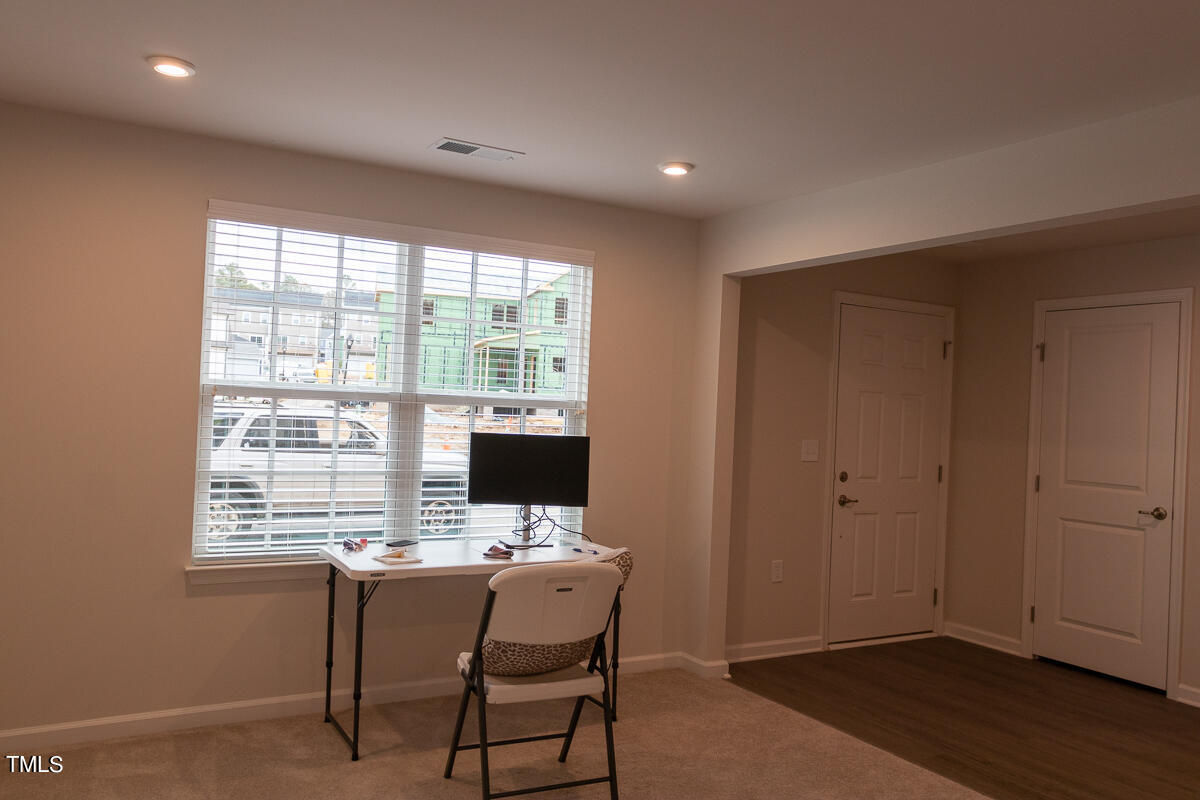 1505 Newpoint Drive Durham, NC 27713 - Photo 18 of 48 a view of a workspace with furniture and a window