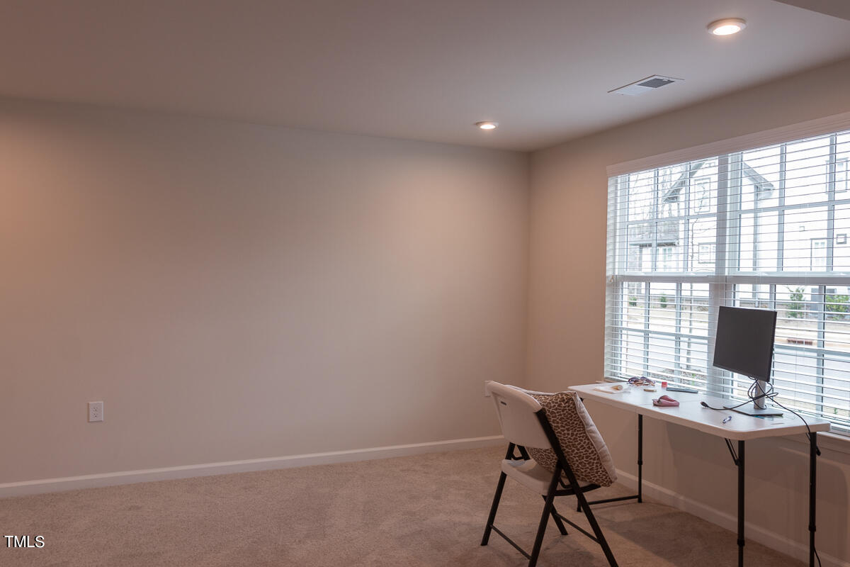 1505 Newpoint Drive Durham, NC 27713 - Photo 19 of 48 a view of a workspace with furniture and a window