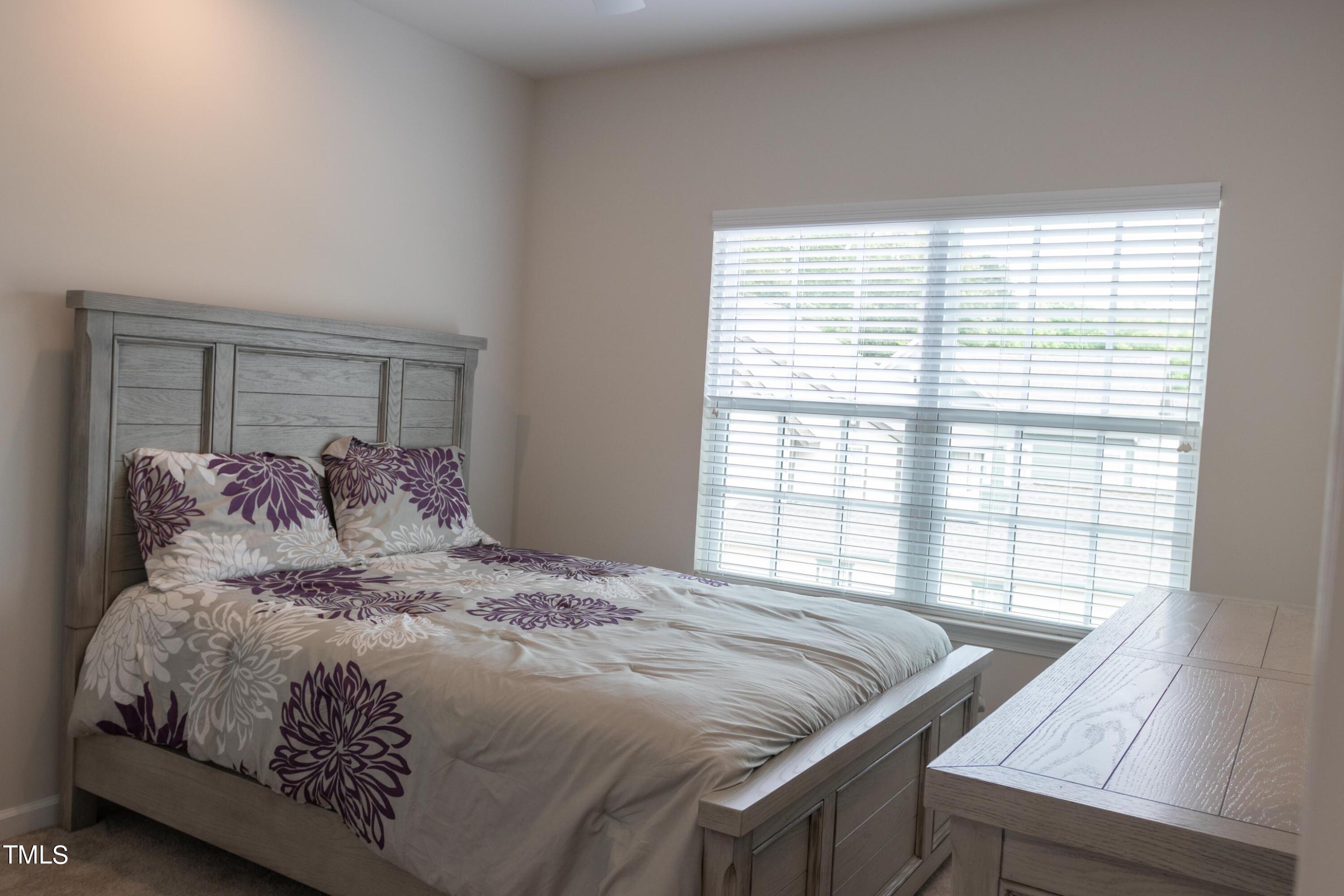 1505 Newpoint Drive Durham, NC 27713 - Photo 21 of 48 a large bed sitting in a bedroom next to a window