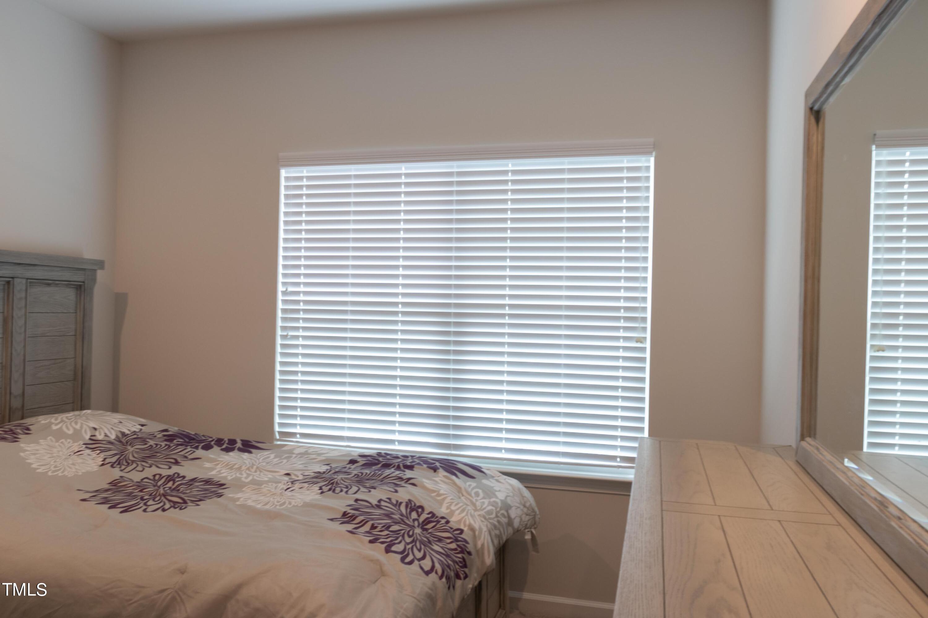 1505 Newpoint Drive Durham, NC 27713 - Photo 22 of 48 a bedroom with a bed and a window