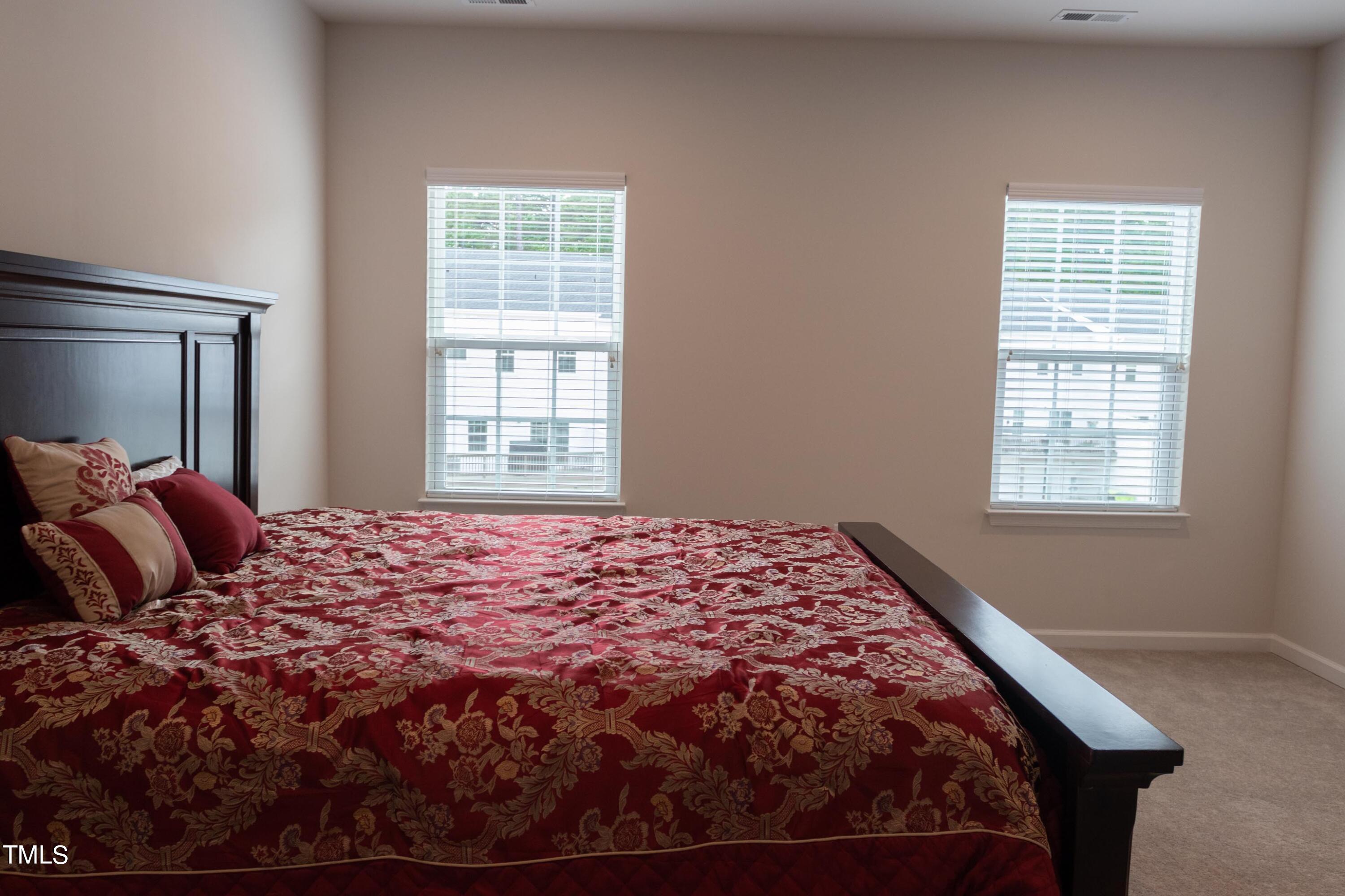 1505 Newpoint Drive Durham, NC 27713 - Photo 24 of 48 a bed sitting in a bedroom next to a window