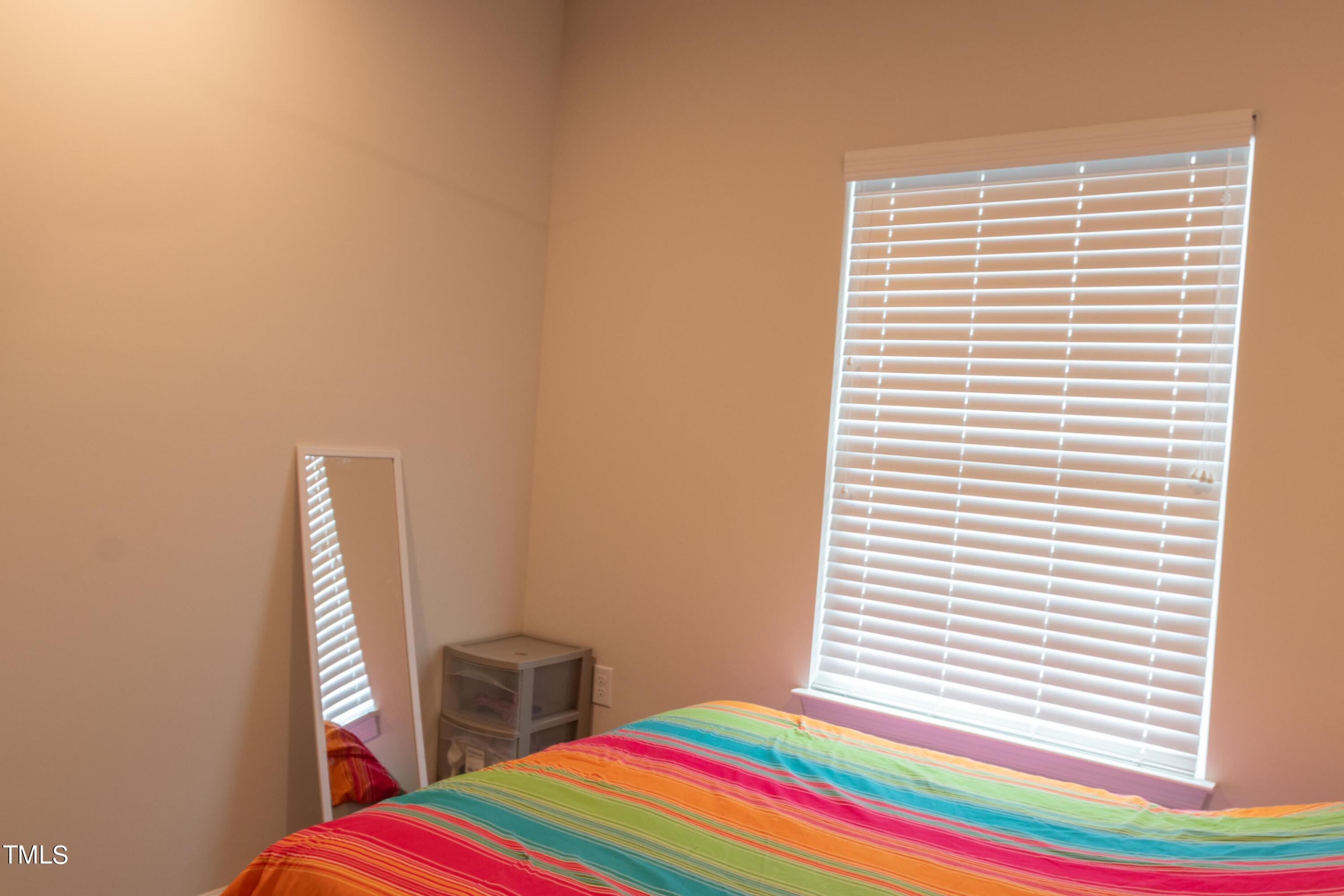 1505 Newpoint Drive Durham, NC 27713 - Photo 31 of 48 a room that has a bed and a window in it