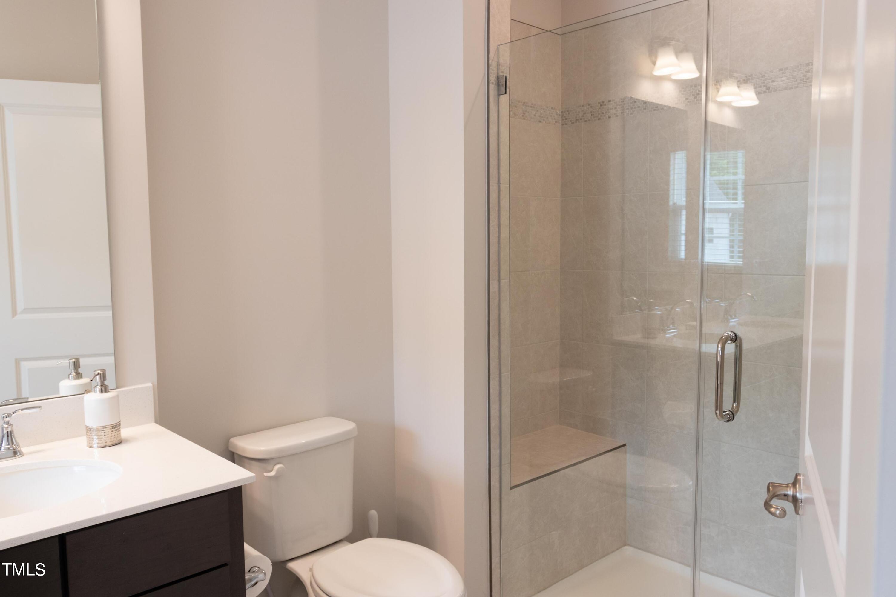 1505 Newpoint Drive Durham, NC 27713 - Photo 38 of 48 a bathroom with a toilet a sink and shower