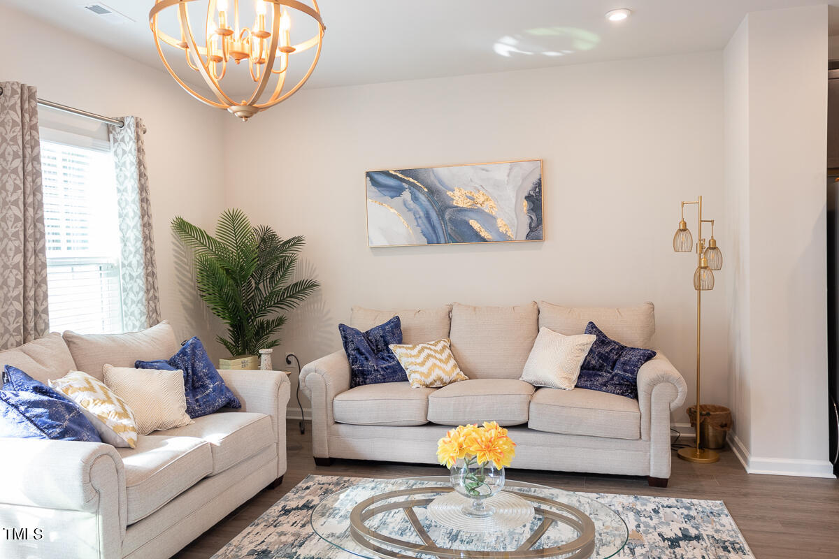1505 Newpoint Drive Durham, NC 27713 - Photo 10 of 48 a living room with furniture a rug and a large window