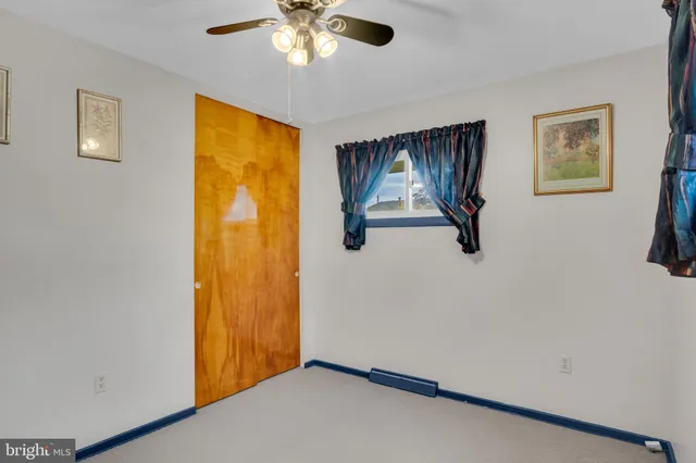 a view of a livingroom with wooden floor and window