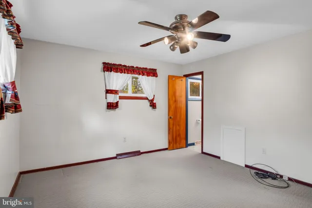 a bathroom with a toilet a sink and a mirror