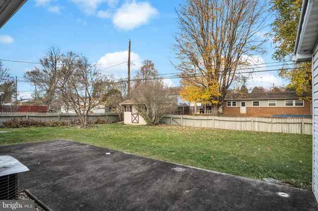 a view of backyard of house with green space