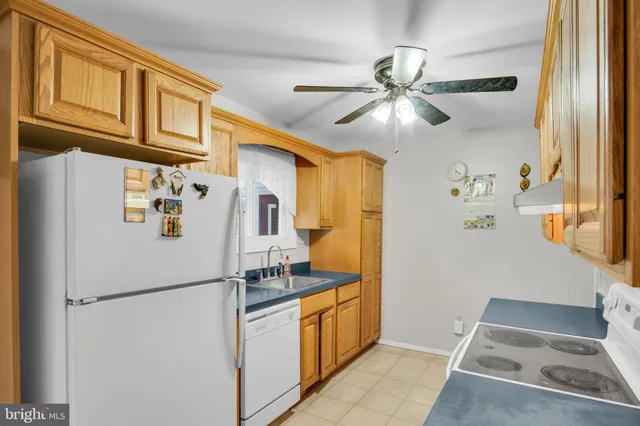 a white refrigerator freezer and a dishwasher in a kitchen