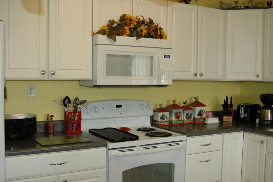 327 Clemons Road Roanoke, VA 24019 - Photo 13 of 35 a kitchen with white cabinets and appliances