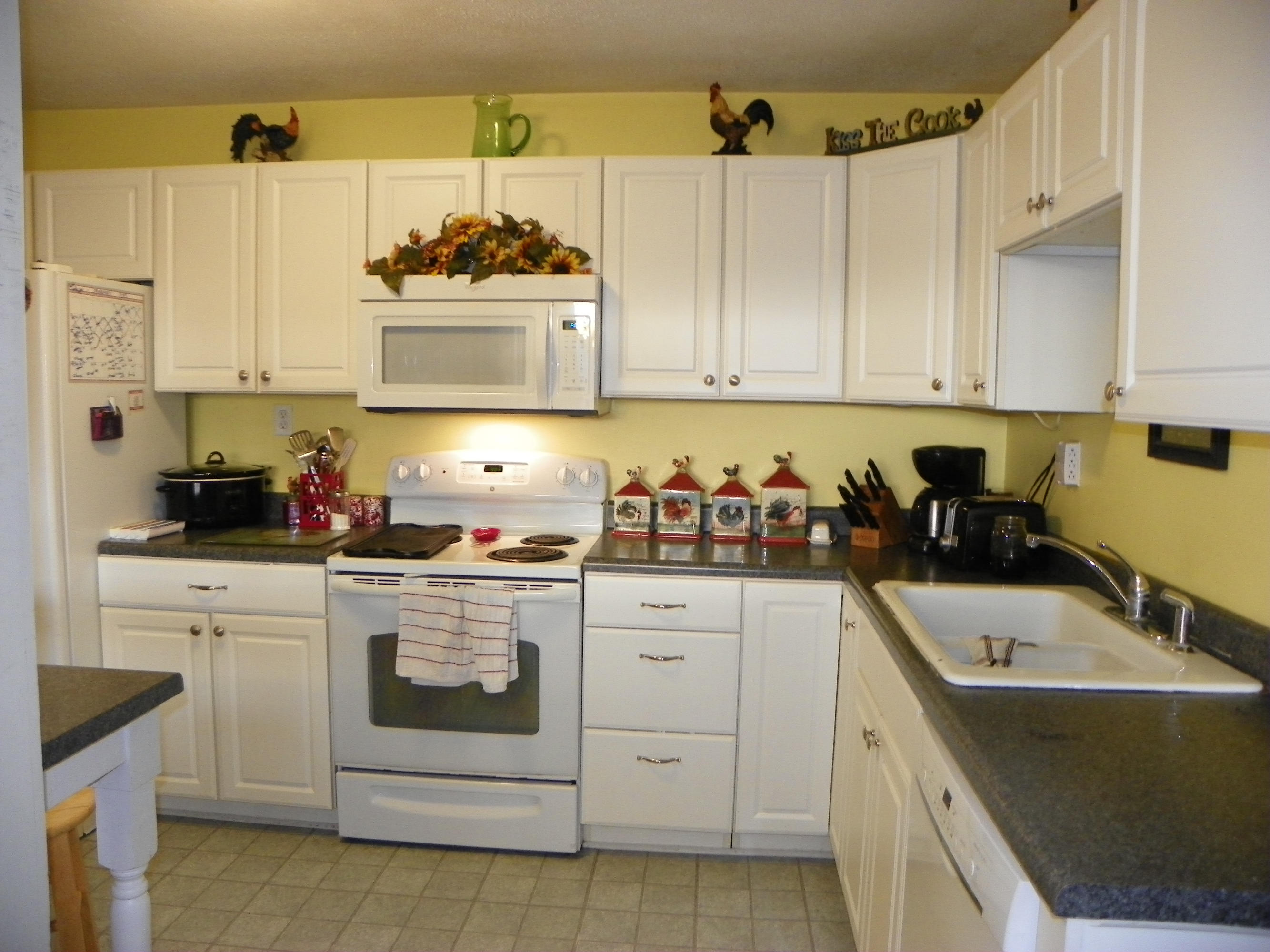 327 Clemons Road Roanoke, VA 24019 - Photo 10 of 35 a kitchen with cabinets a sink and white appliances