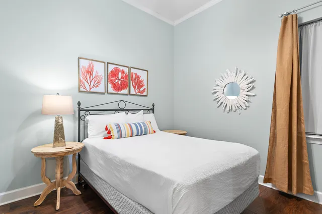 a bedroom with a bed and a painting on the wall