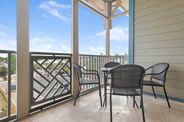 a view of a chair and tables in the balcony