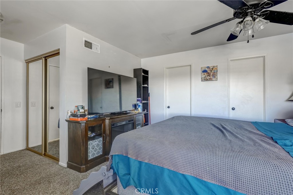 4687 Knickerbocker Lane Riverside, CA 92501 - Photo 12 of 27 a bedroom with a bed and a dresser