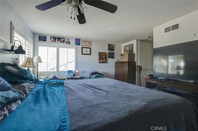 a large bedroom with a bed and furniture