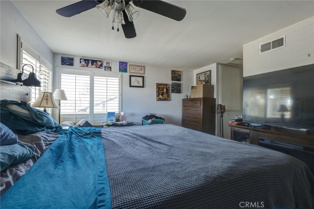 4687 Knickerbocker Lane Riverside, CA 92501 - Photo 13 of 27 a large bedroom with a bed and furniture