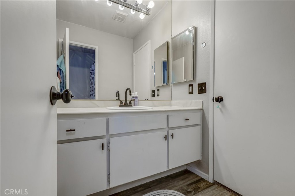 4687 Knickerbocker Lane Riverside, CA 92501 - Photo 16 of 27 a bathroom with a sink and a mirror