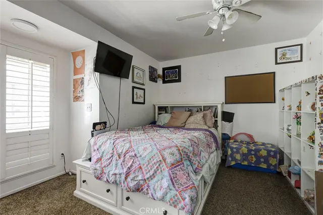 a bedroom with a bed and flat tv screen