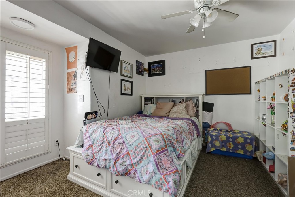 4687 Knickerbocker Lane Riverside, CA 92501 - Photo 18 of 27 a bedroom with a bed and flat tv screen