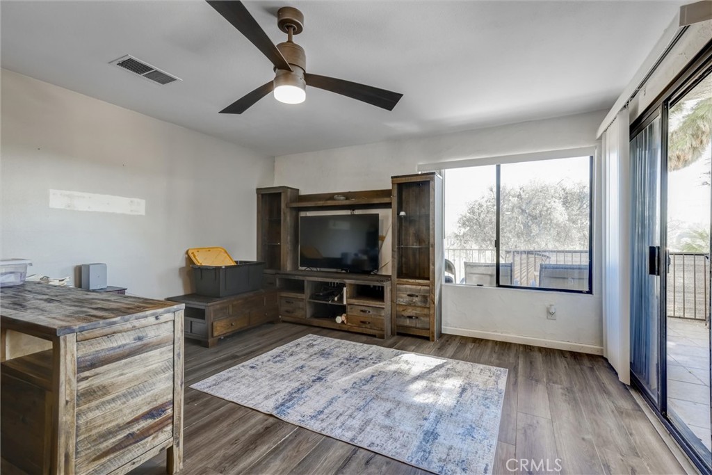4687 Knickerbocker Lane Riverside, CA 92501 - Photo 2 of 27 a living room with furniture and a flat screen tv