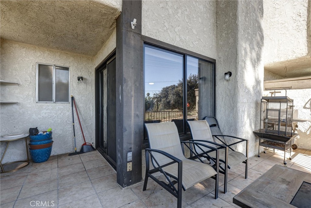 4687 Knickerbocker Lane Riverside, CA 92501 - Photo 21 of 27 a view of a livingroom with furniture and windows