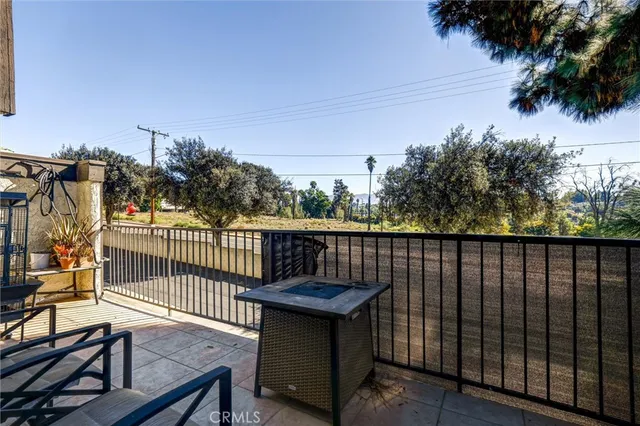 a view of a balcony with wooden fence and floor