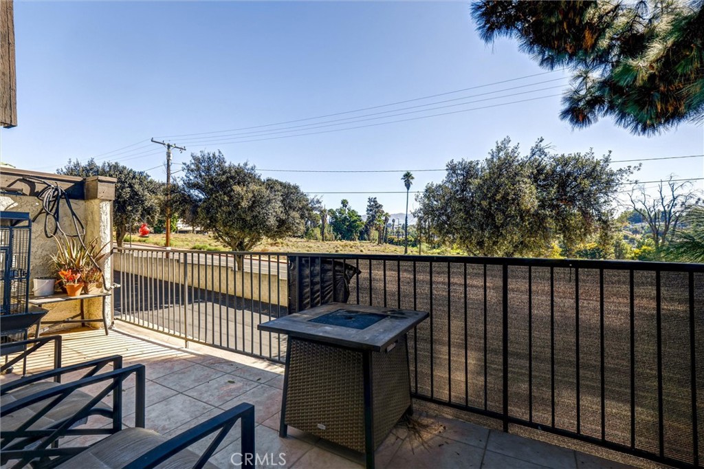 4687 Knickerbocker Lane Riverside, CA 92501 - Photo 22 of 27 a view of a balcony with wooden fence and floor