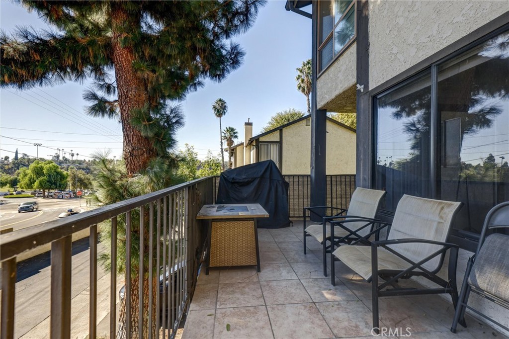 4687 Knickerbocker Lane Riverside, CA 92501 - Photo 23 of 27 a view of a chairs and table in the balcony