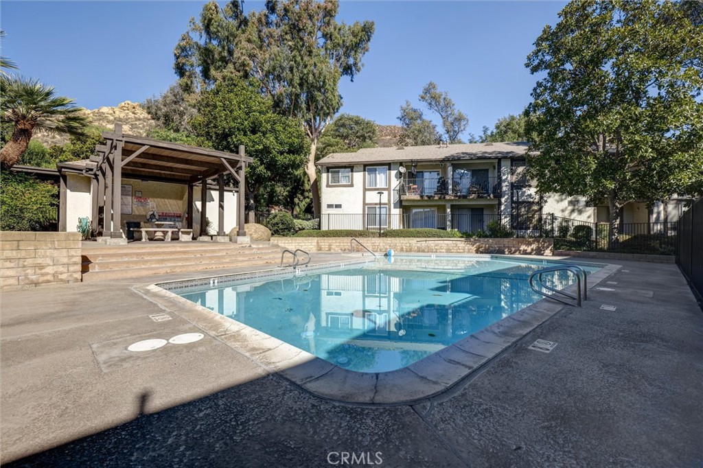 4687 Knickerbocker Lane Riverside, CA 92501 - Photo 26 of 27 a view of a house with a yard porch and sitting area