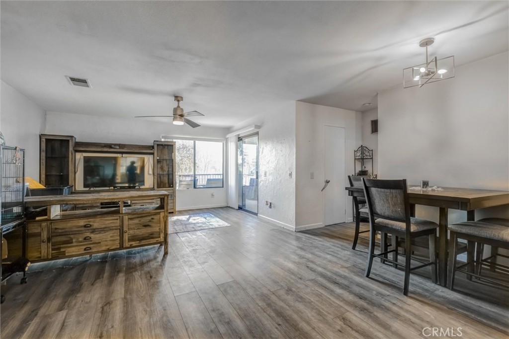 4687 Knickerbocker Lane Riverside, CA 92501 - Photo 3 of 27 a view of a dining room with furniture window and wooden floor