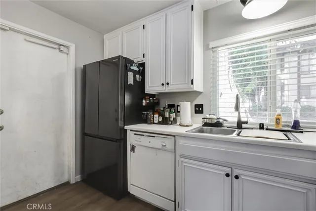 a kitchen with appliances cabinets and a sink
