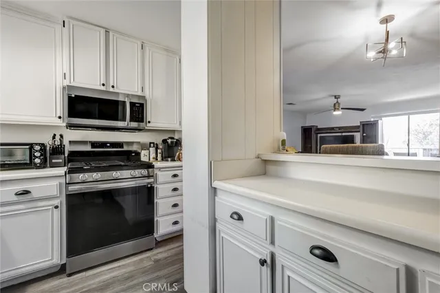 a kitchen with cabinets stainless steel appliances and a counter space