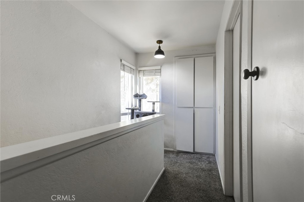 4687 Knickerbocker Lane Riverside, CA 92501 - Photo 10 of 27 a view of a hallway with a kitchen