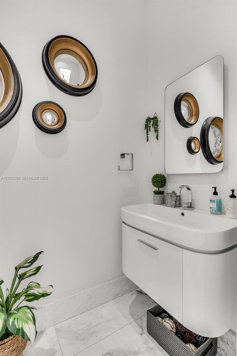230 West McIntyre Street Key Biscayne, FL 33149 - Photo 23 of 53 a bathroom with a sink and a mirror