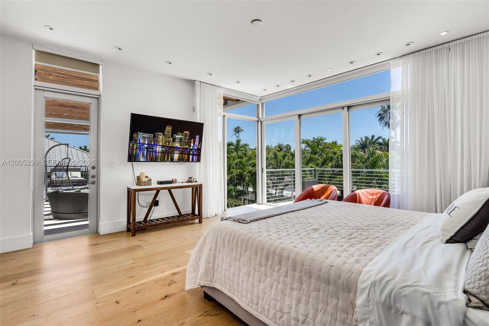230 West McIntyre Street Key Biscayne, FL 33149 - Photo 29 of 53 a bedroom with a bed a fireplace and a large window