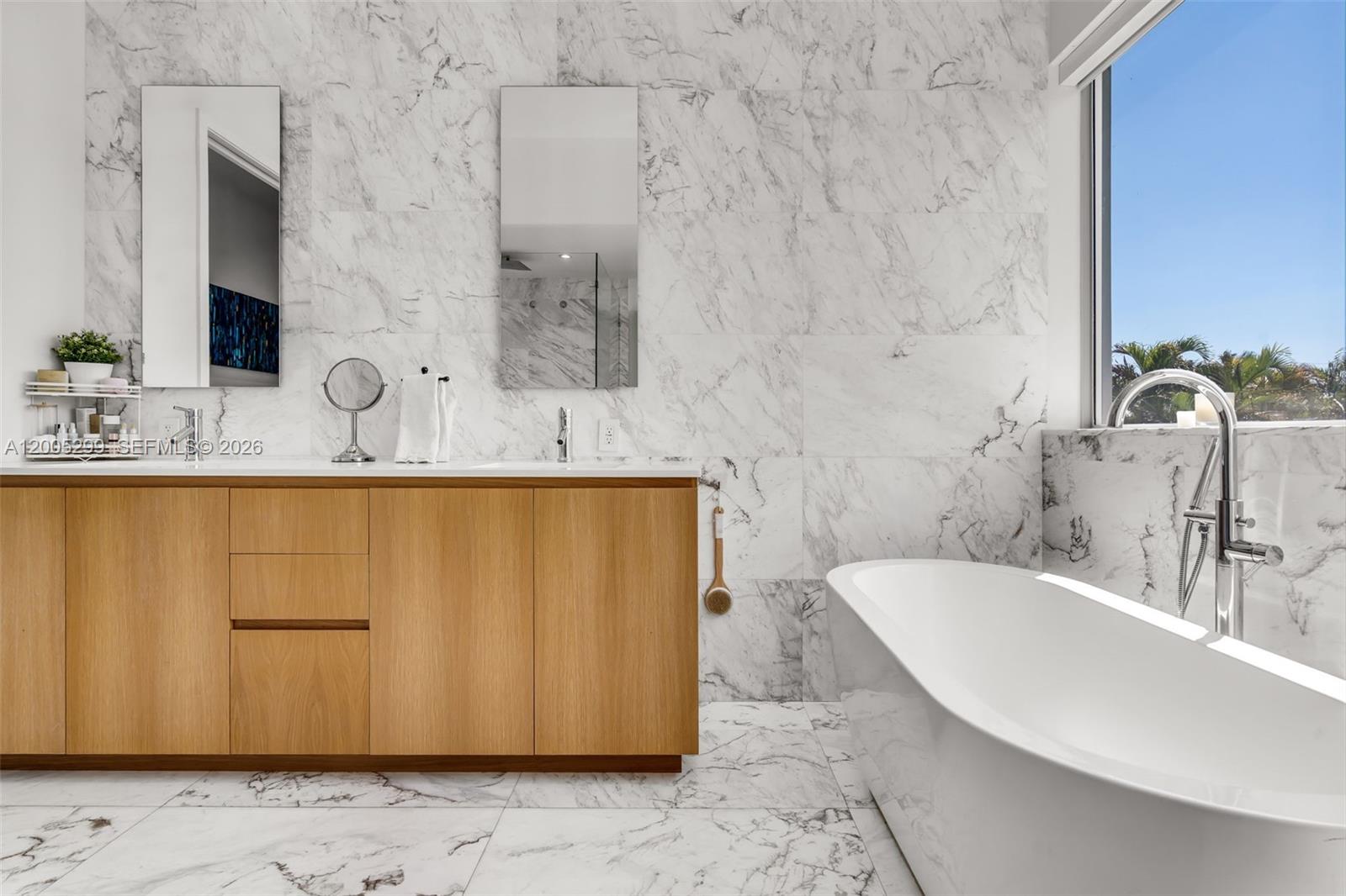 230 West McIntyre Street Key Biscayne, FL 33149 - Photo 32 of 53 a bathroom with a sink and a mirror