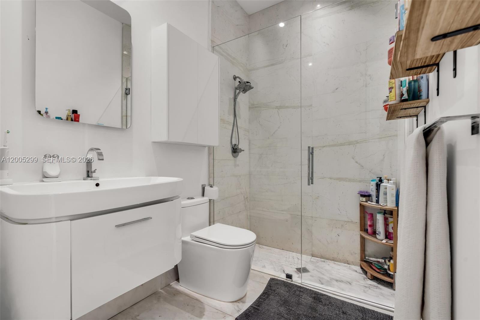 230 West McIntyre Street Key Biscayne, FL 33149 - Photo 44 of 53 a bathroom with a sink a toilet and shower