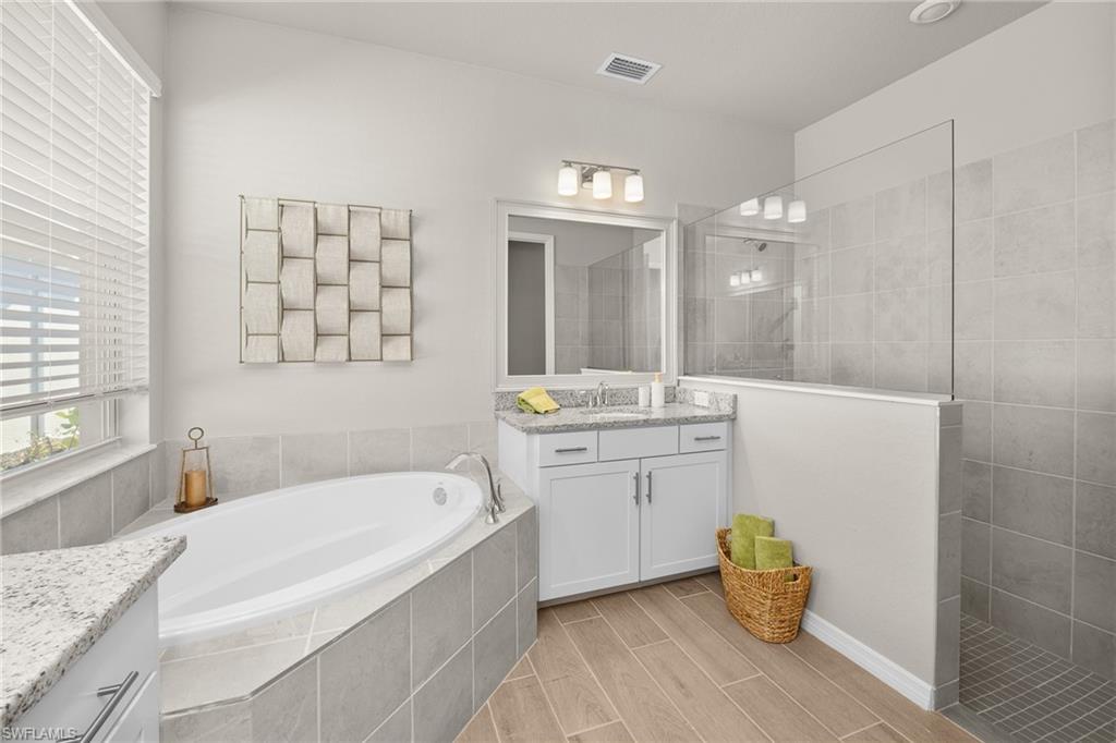 15048 Redbud Lane Punta Gorda, FL 33955 - Photo 23 of 34 a bathroom with a granite countertop sink mirror and bathtub