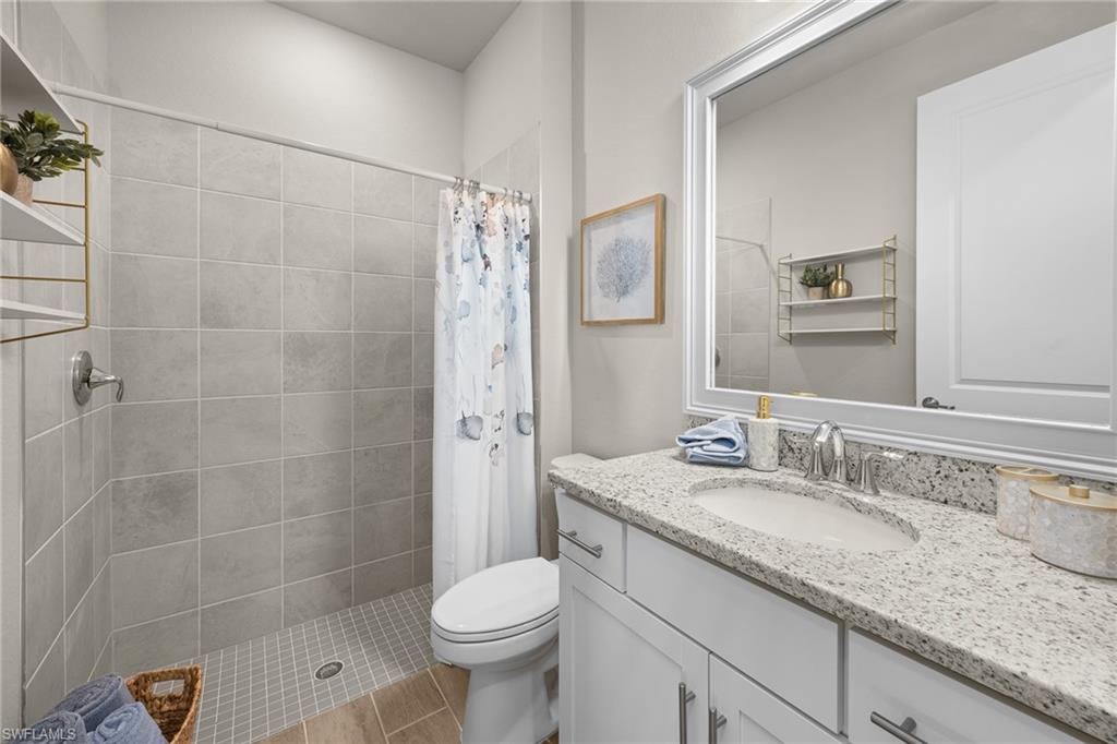 15048 Redbud Lane Punta Gorda, FL 33955 - Photo 24 of 34 a bathroom with a granite countertop sink toilet and shower