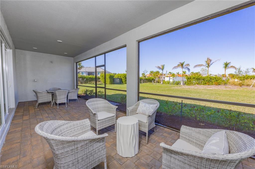 15048 Redbud Lane Punta Gorda, FL 33955 - Photo 25 of 34 a living room with furniture and a floor to ceiling window